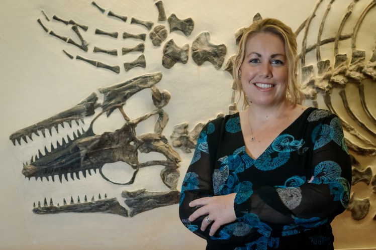 Laura standing in front of a mosasaur skeleton at the Sternberg Museum. 